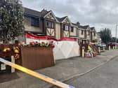 Floral tributes outside a house