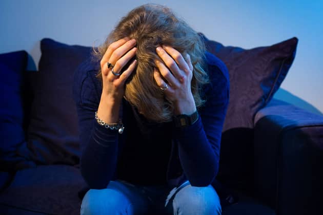 A woman with her head in her hands